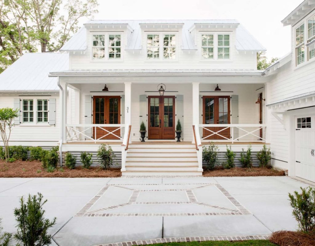 Home with Sherwin Williams Pure White  exterior paint color, French blue shutters and warm wood doors.