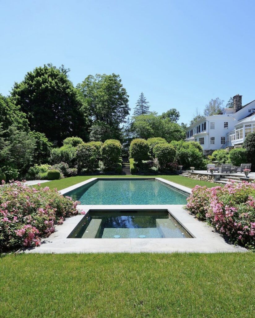 Backyard Pool and Hot Tub with Hamptons-inspired style and pink roses in landscape design from William Pitt Real Estate